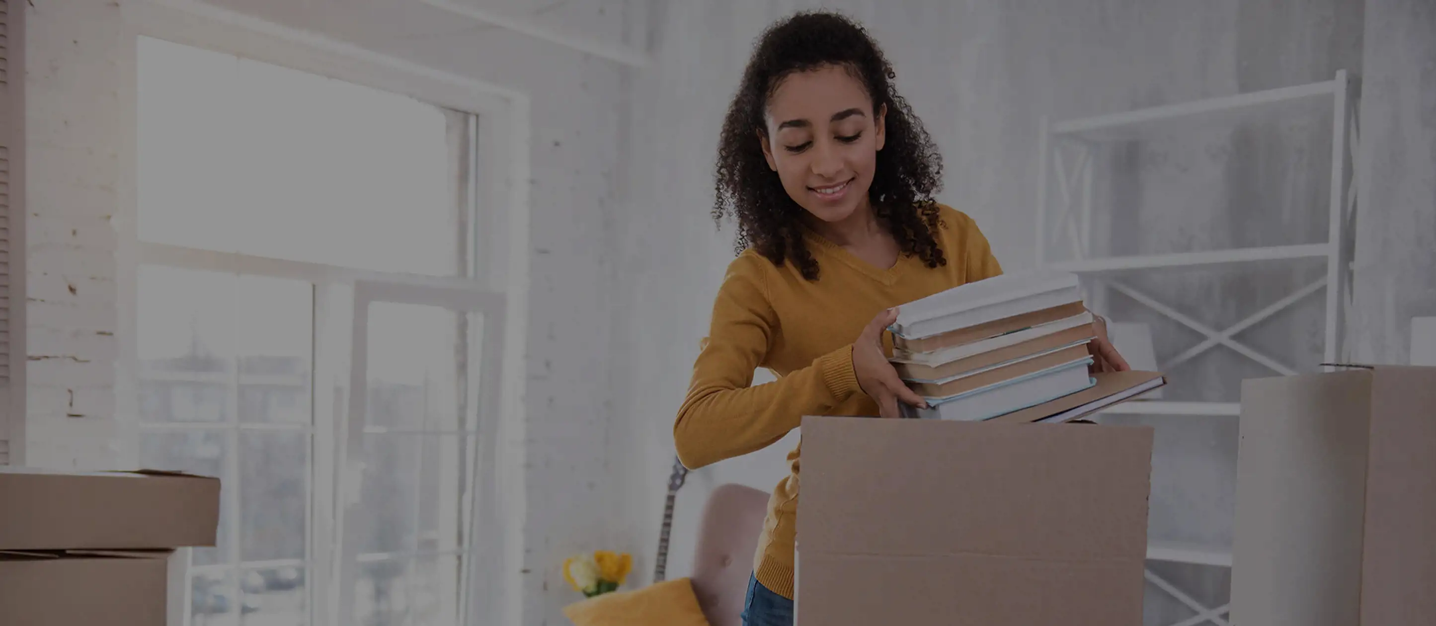 College student boxing up books for self storage