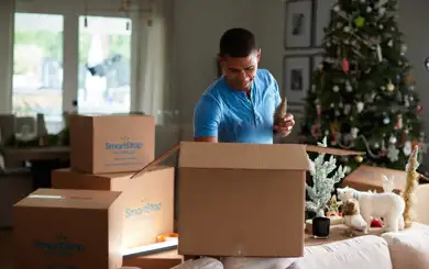Man packing away Holiday decoration to take to storage | SmartStop