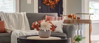 cozy fall living room with throw blanket patterned pillow wreath on door