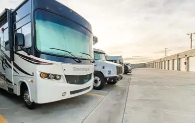 Image of RV, Truck and Car in uncovered self storage spaces for cars at SmartStop